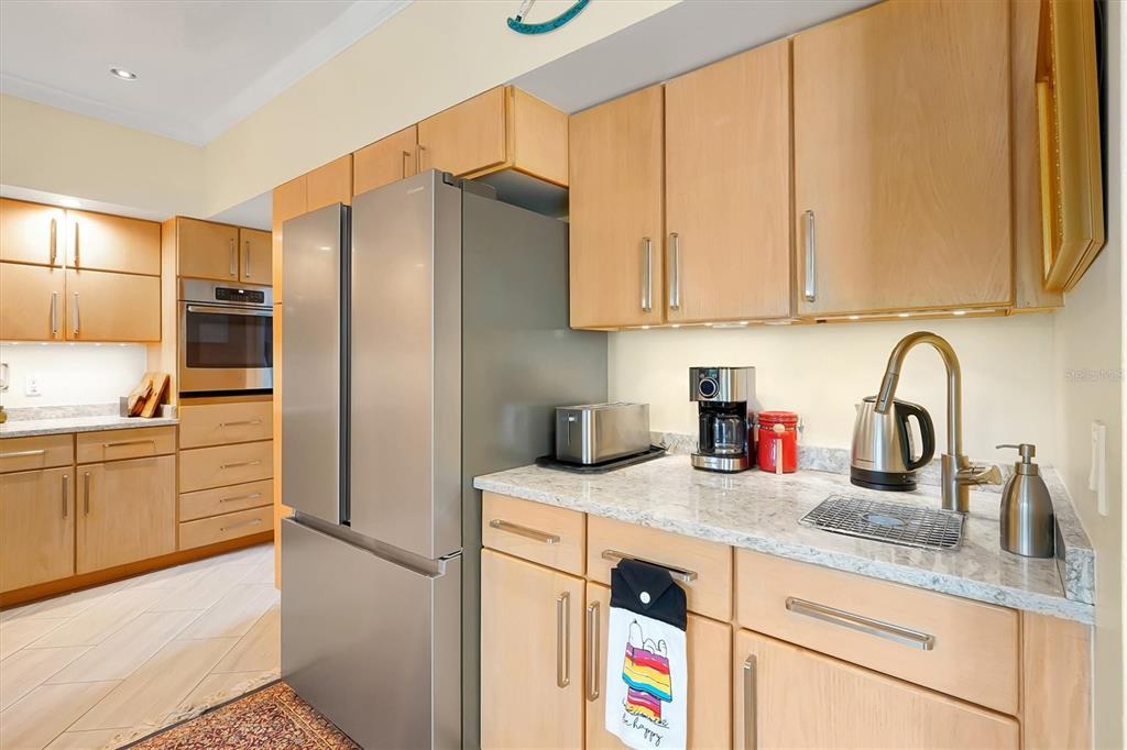 139 Woden Way Winter Haven, FL 33884 - Photo 21 of 60 a kitchen with stainless steel appliances granite countertop a refrigerator sink and cabinets