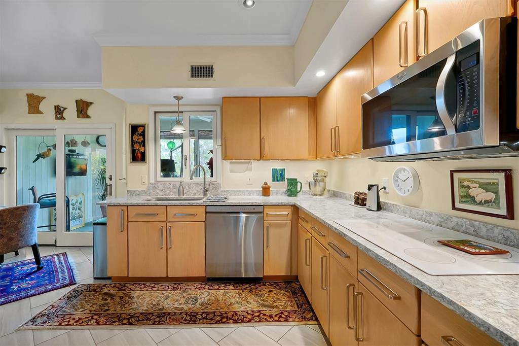 139 Woden Way Winter Haven, FL 33884 - Photo 23 of 60 a kitchen with stainless steel appliances granite countertop a sink stove and cabinets