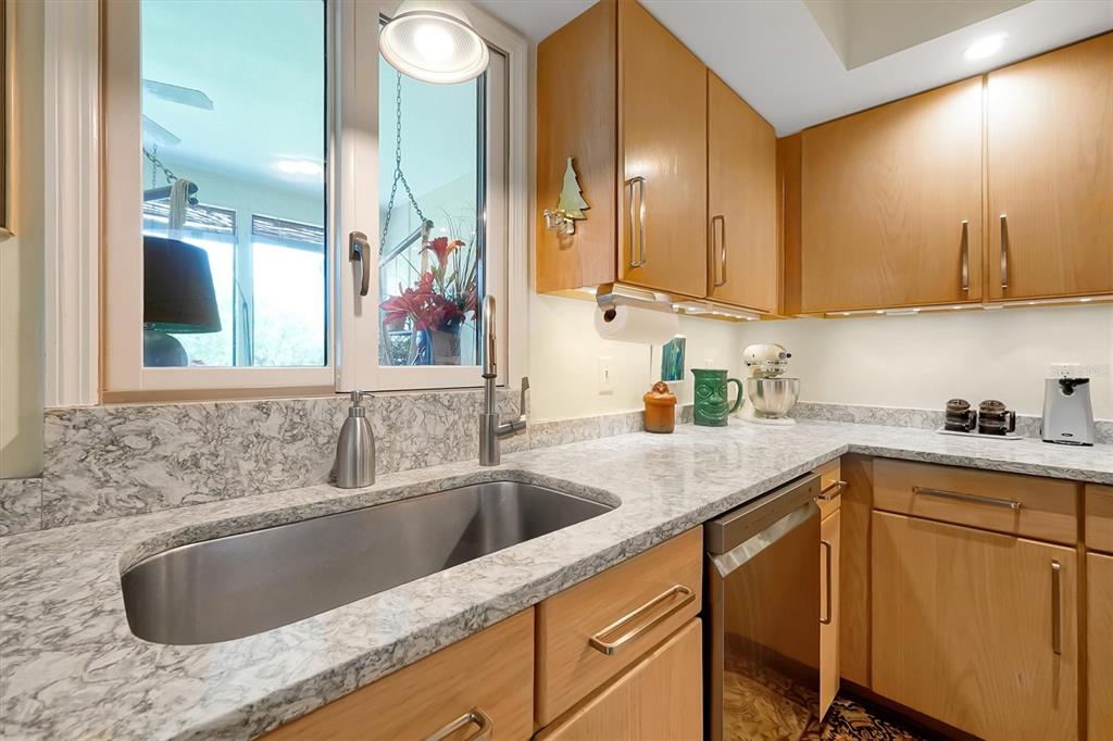 139 Woden Way Winter Haven, FL 33884 - Photo 24 of 60 a kitchen with granite countertop a sink and cabinets
