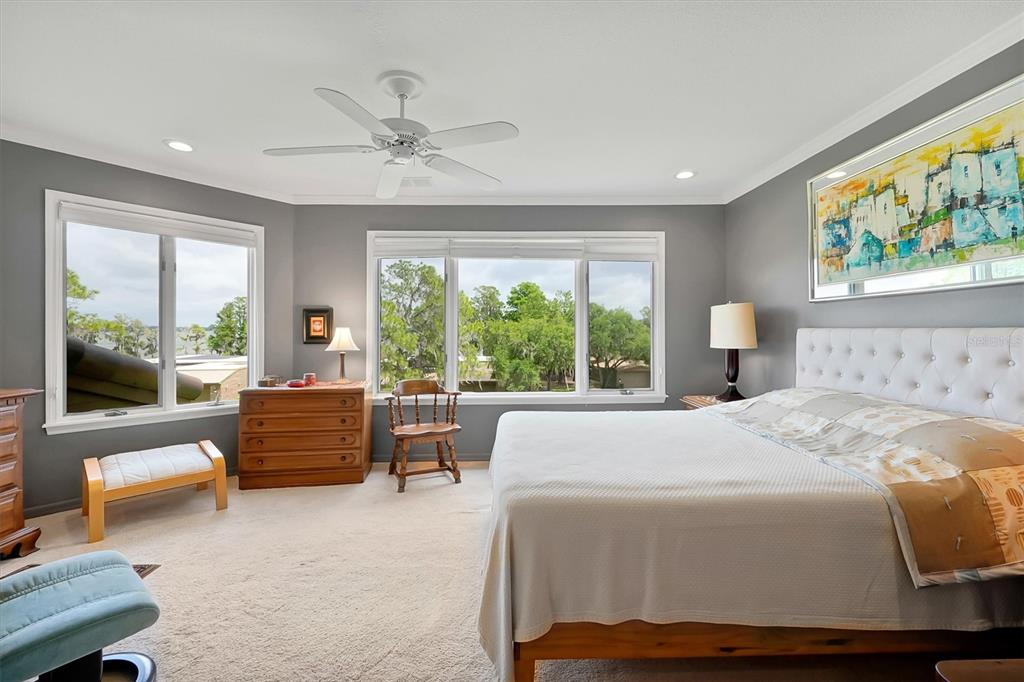 139 Woden Way Winter Haven, FL 33884 - Photo 29 of 60 a bedroom with a balcony a bed and a couch