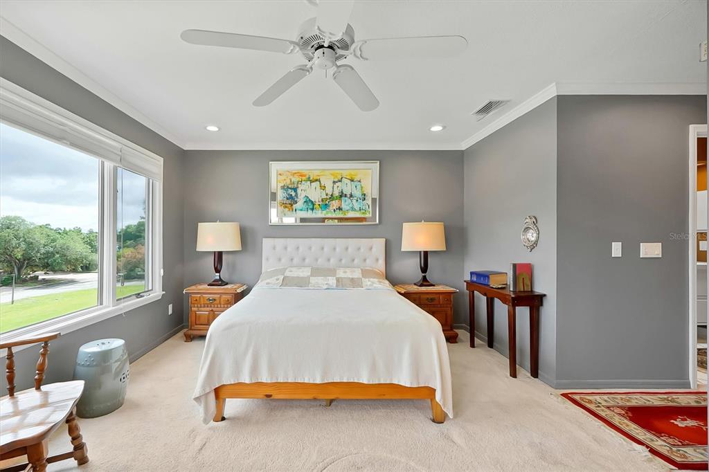 139 Woden Way Winter Haven, FL 33884 - Photo 30 of 60 a spacious bedroom with a bed and a large window