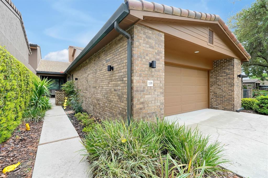 139 Woden Way Winter Haven, FL 33884 - Photo 3 of 60 a pathway of a house with potted plants