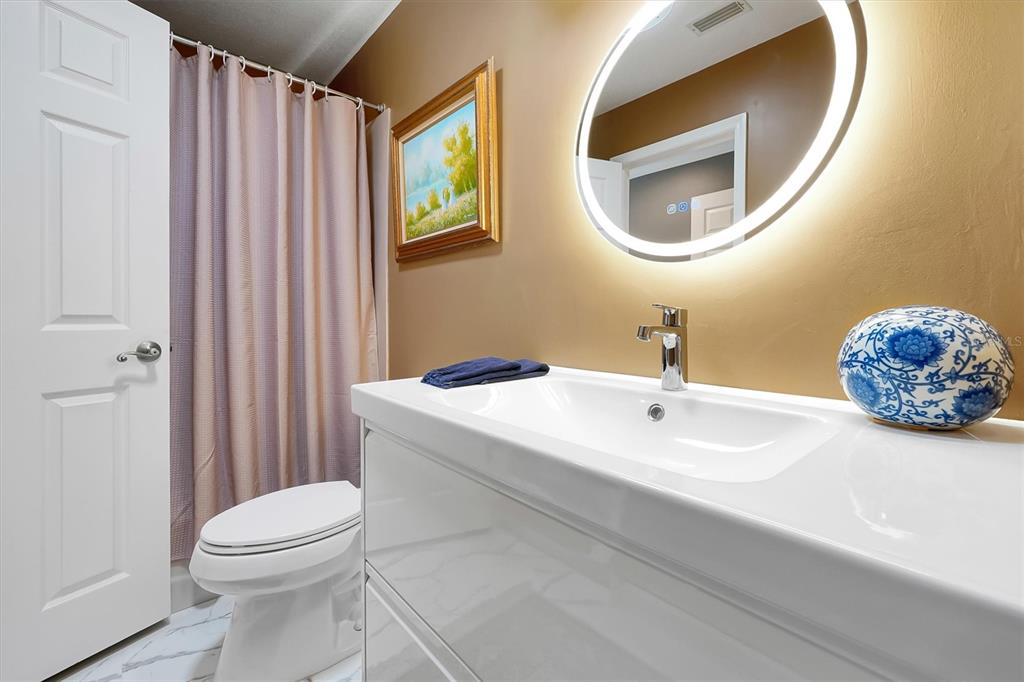139 Woden Way Winter Haven, FL 33884 - Photo 32 of 60 a bathroom with a sink a mirror and toilet