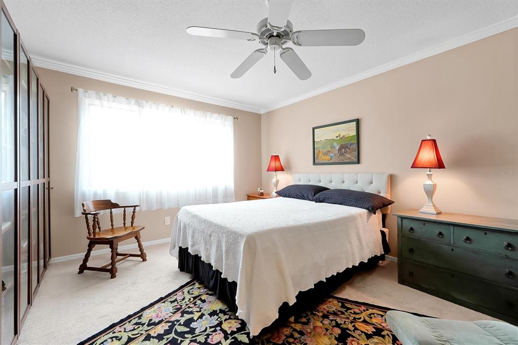 139 Woden Way Winter Haven, FL 33884 - Photo 34 of 60 a bedroom with a bed and a chandelier