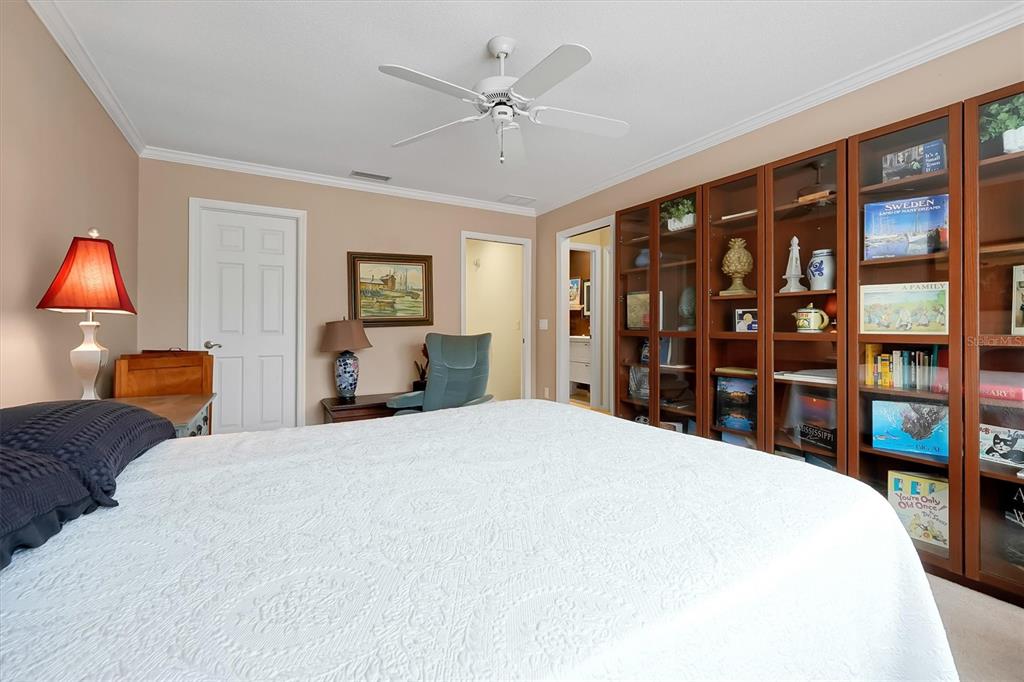 139 Woden Way Winter Haven, FL 33884 - Photo 36 of 60 a bedroom with a large bed and a chandelier