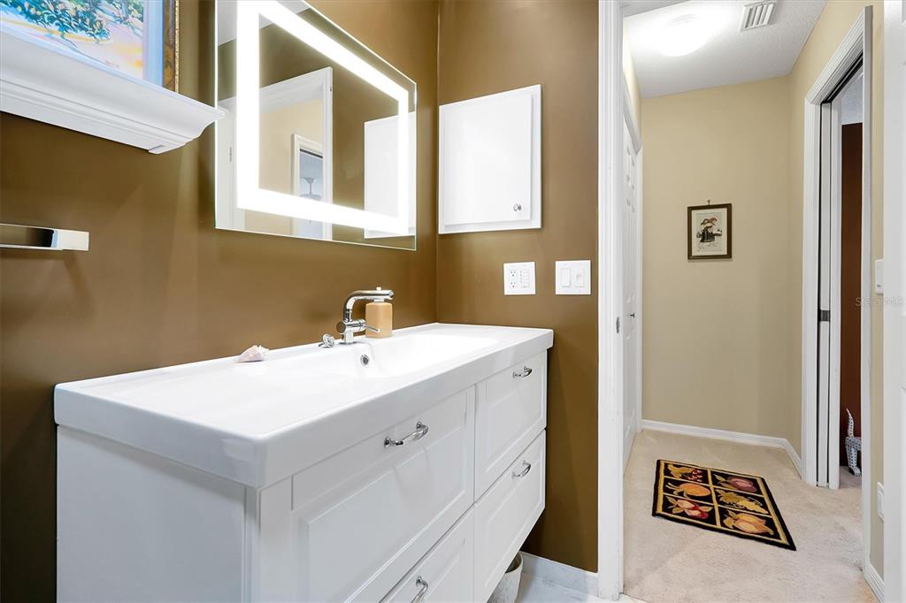 139 Woden Way Winter Haven, FL 33884 - Photo 38 of 60 a utility room with a sink a vanity and a mirror