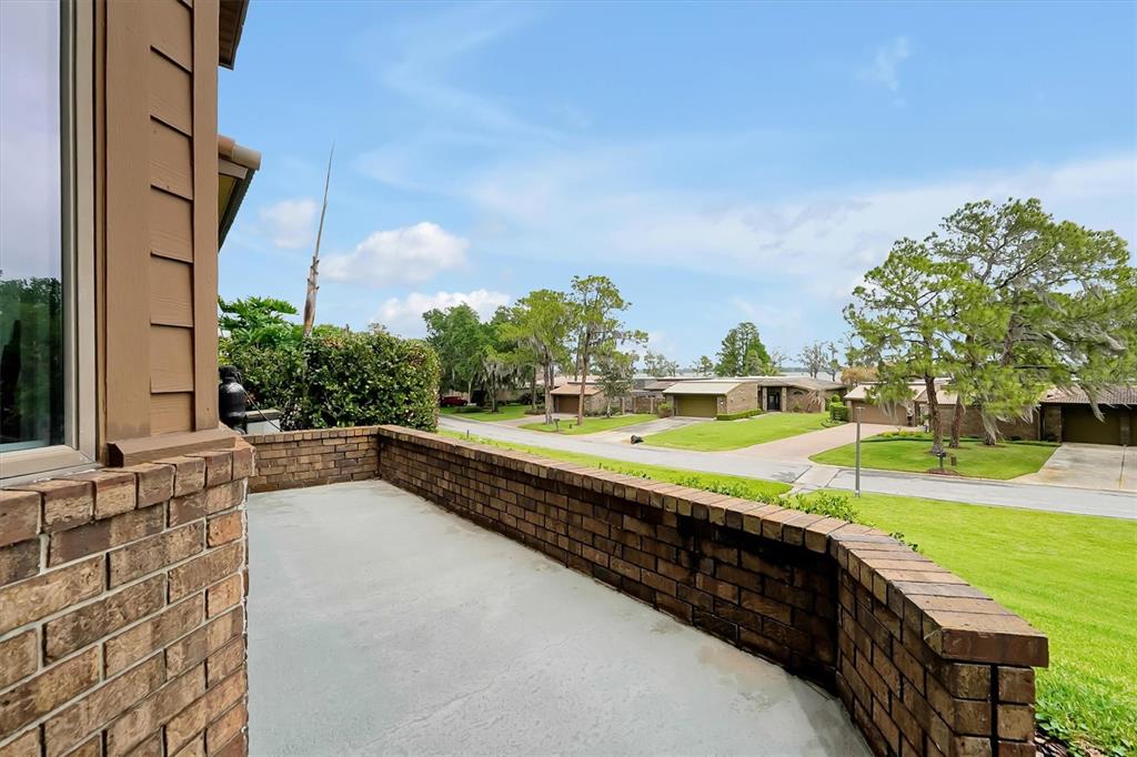 139 Woden Way Winter Haven, FL 33884 - Photo 42 of 60 a view of a swimming pool with an outdoor seating and a garden
