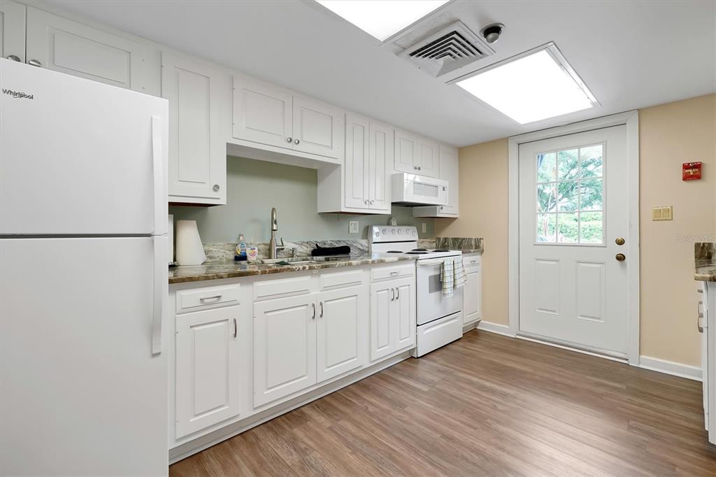 139 Woden Way Winter Haven, FL 33884 - Photo 53 of 60 a kitchen with white cabinets and white appliances
