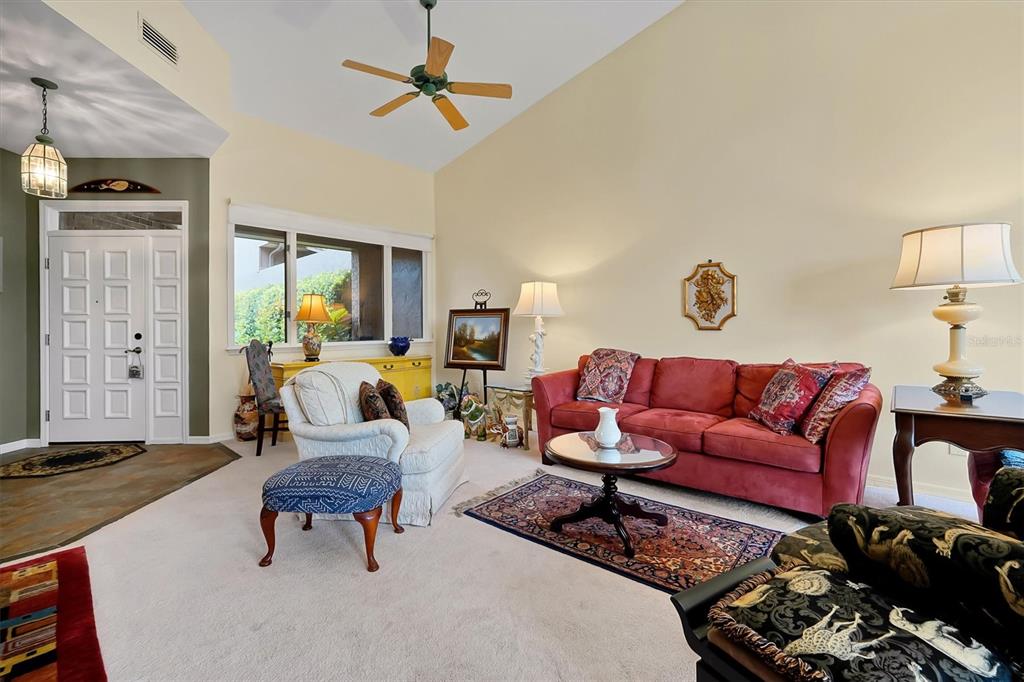 139 Woden Way Winter Haven, FL 33884 - Photo 7 of 60 a living room with furniture a rug and a window