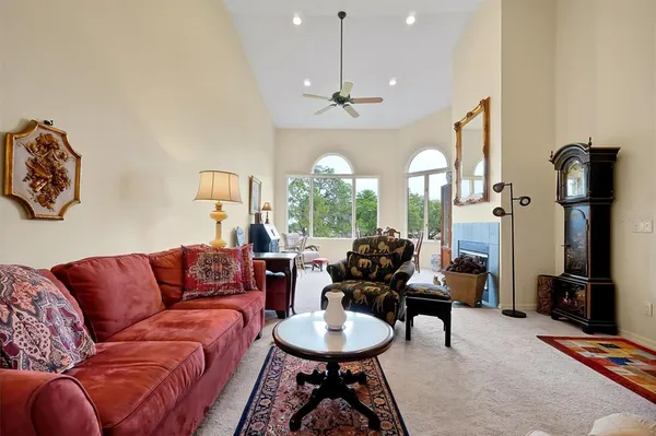 a dining room with furniture a fireplace and a large window