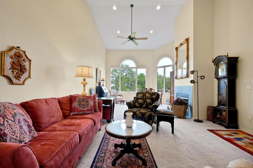 139 Woden Way Winter Haven, FL 33884 - Photo 8 of 60 a living room with furniture a fireplace and a chandelier