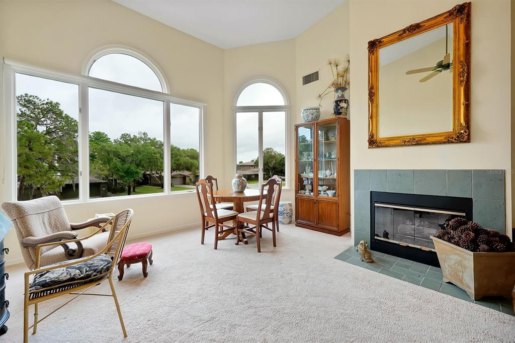 139 Woden Way Winter Haven, FL 33884 - Photo 10 of 60 a dining room with furniture a fireplace and a large window