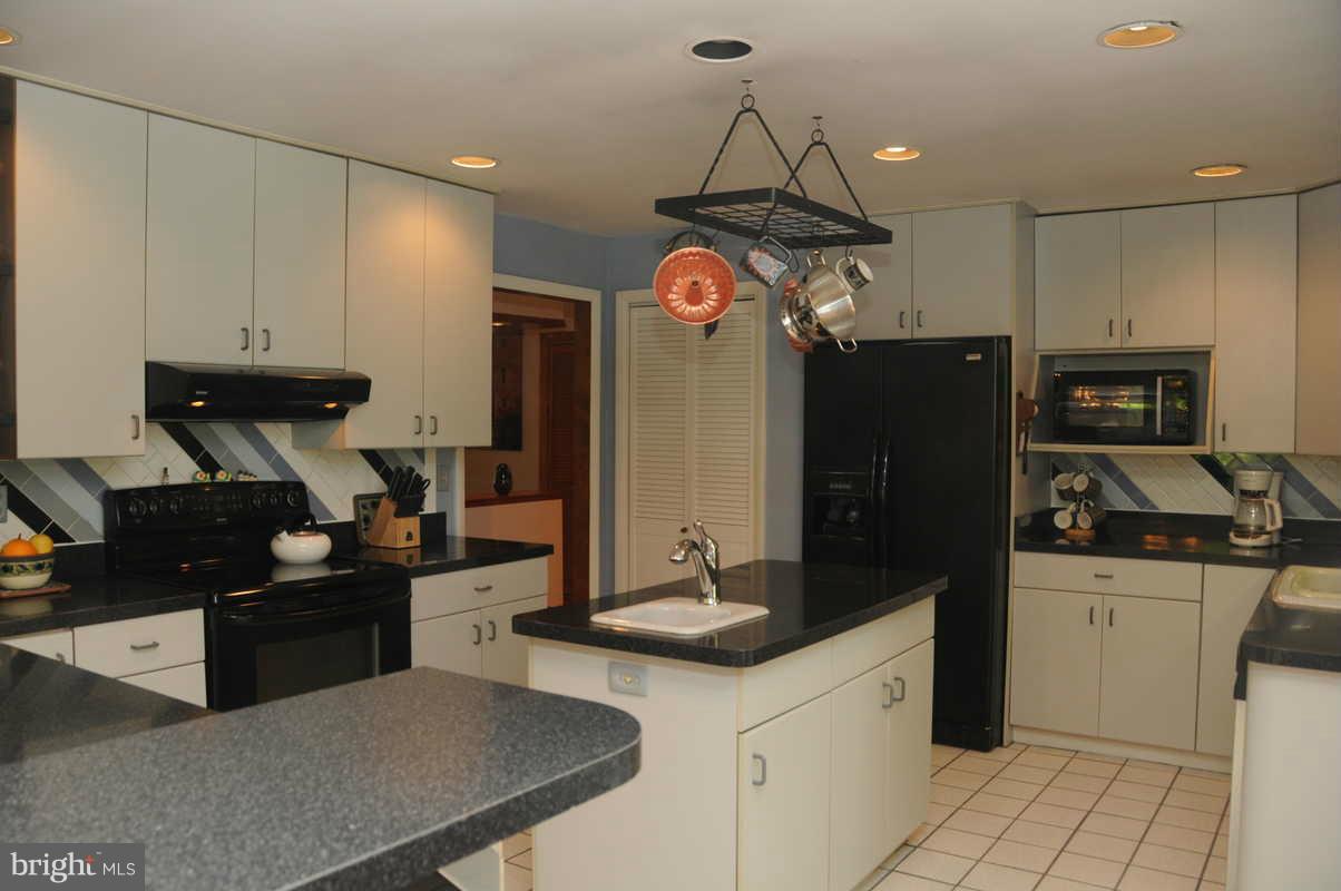 16311 Accolawn Road Accokeek, MD 20607 - Photo 5 of 17 a kitchen with stainless steel appliances a sink stove and refrigerator