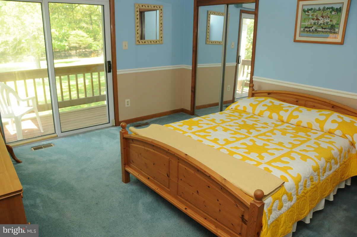 16311 Accolawn Road Accokeek, MD 20607 - Photo 9 of 17 a bed sitting in a bedroom next to a window