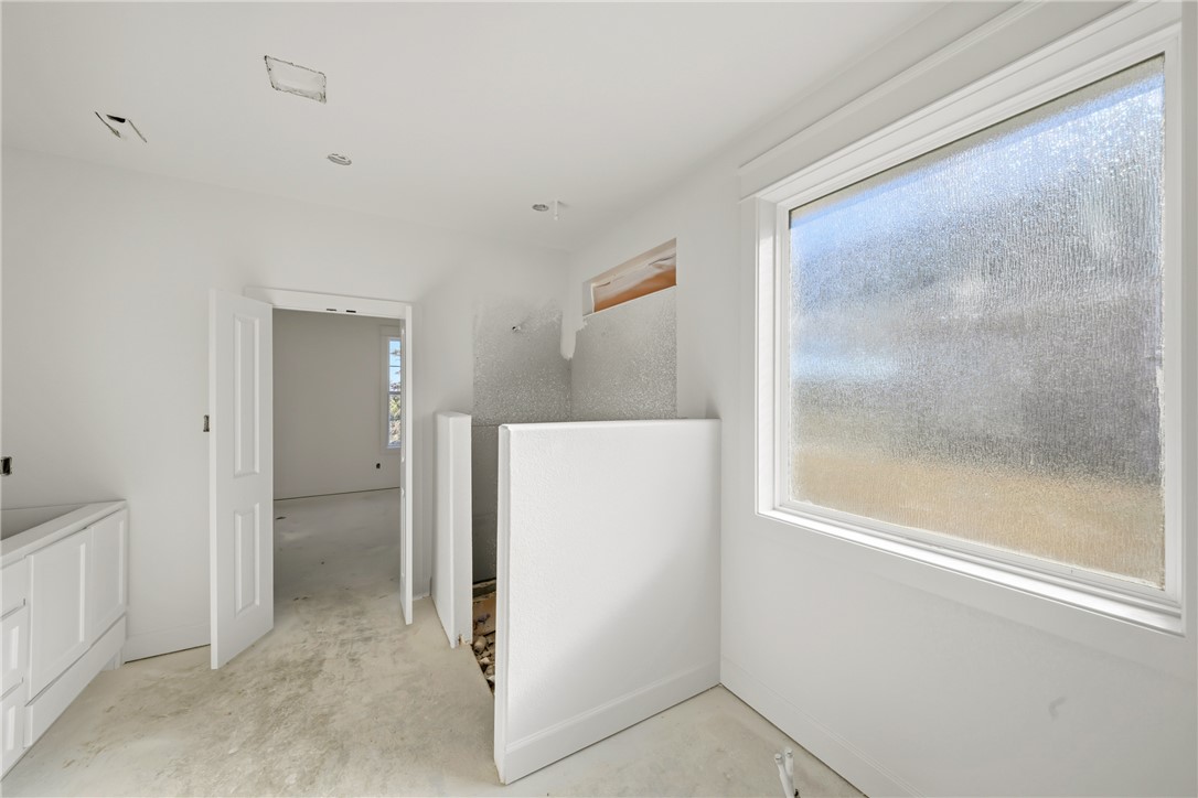 5103 Booth Falls Trail Bryan, TX 77802 - Photo 11 of 18 Primary bathroom featuring large window and walk in shower.