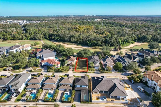 an aerial view of residential building and lake