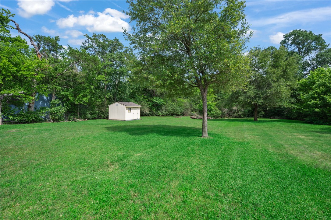 715 Inwood Drive Bryan, TX 77802 - Photo 10 of 34 a backyard of a house with lots of green space