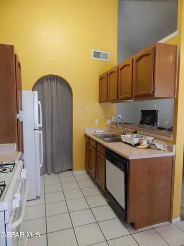 a kitchen with a sink cabinets and appliances