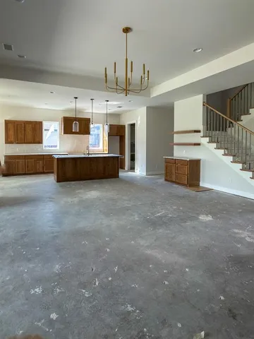 a living room with furniture and a chandelier