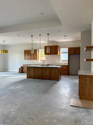 a large kitchen with cabinets and a stainless steel appliances