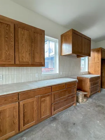 a kitchen with cabinets and window