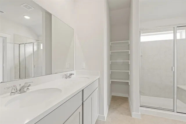 a bathroom with a double vanity sink and a mirror