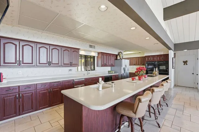 a spacious bathroom with a granite countertop sink and a mirror