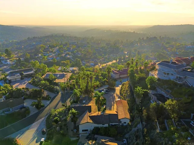 an aerial view of a house with a yard and garden
