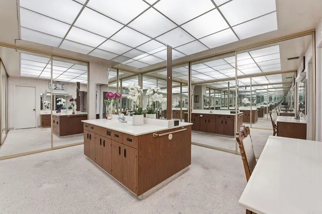 a living room with furniture pool table flat screen tv and windows