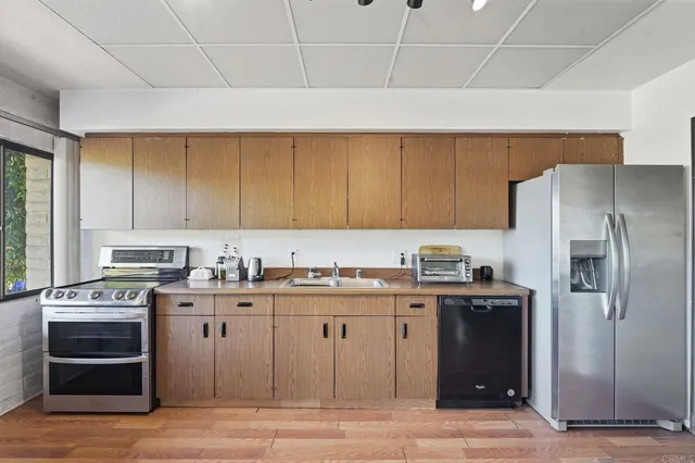 a view of a balcony with wooden chairs and a table