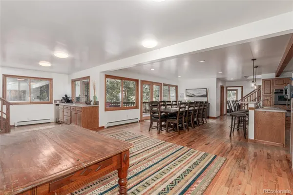 a living room with furniture a wooden floor and next to a window