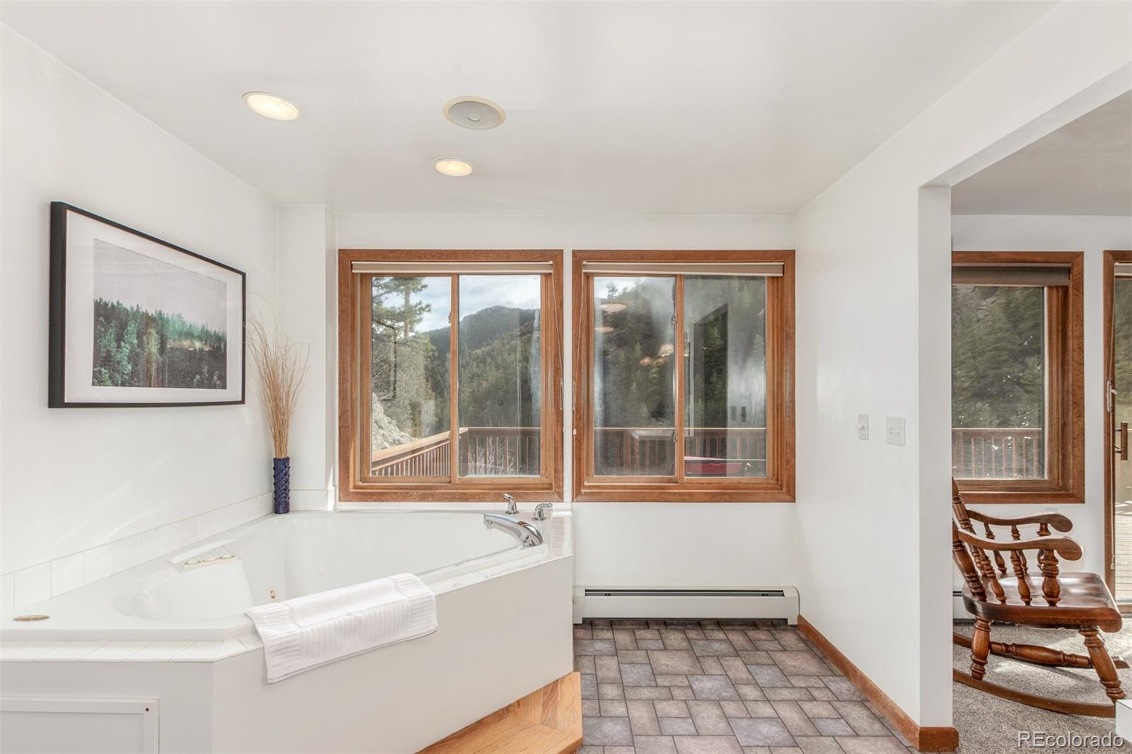 11543 County Road 43 Drake, CO 80515 - Photo 21 of 50 a bathroom with a bathtub and a window