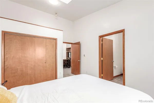 a bedroom with a bed and a mirror