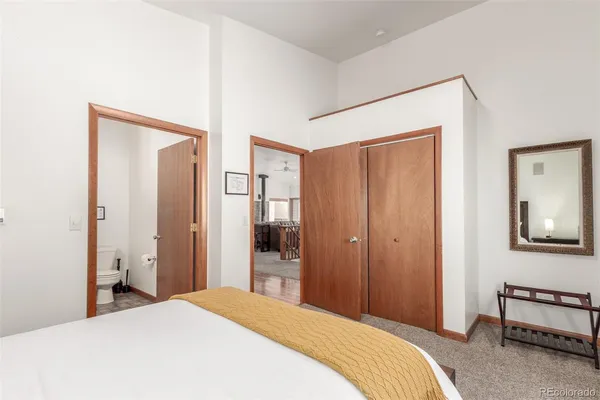 a bedroom with a bed and a mirror