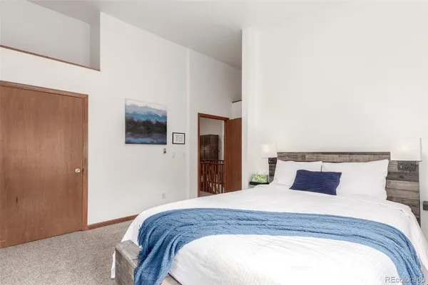 a bedroom with a large bed and a flat screen tv