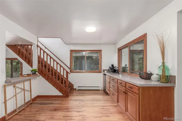 a living room with wooden floor and a large window