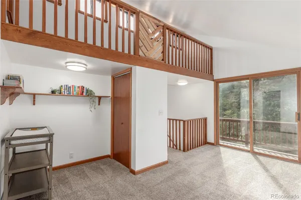 a view of a hallway with kitchen and entryway