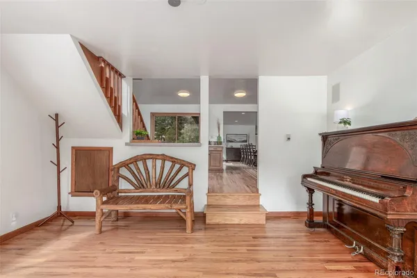 a living room with furniture and a piano