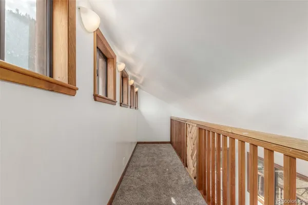 a balcony with wooden floor and trees