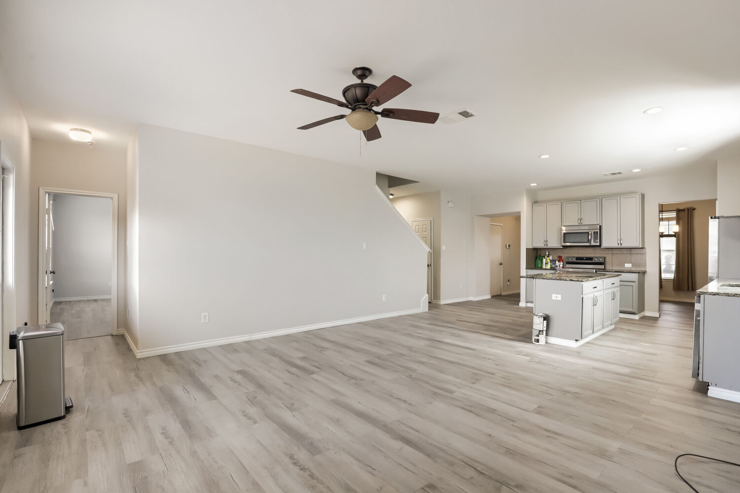 153 Marcheeta Way Leander, TX 78641 - Photo 3 of 17 Smooth hard surface flooring sweeps across an expansive open layout connecting living space to kitchen.
