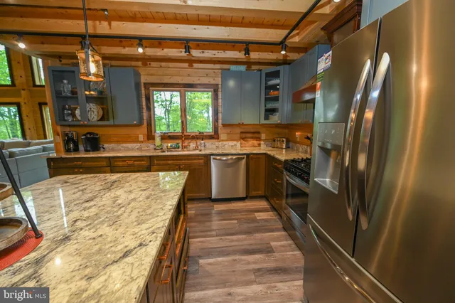 a living room with furniture a flat screen tv and floor to ceiling windows