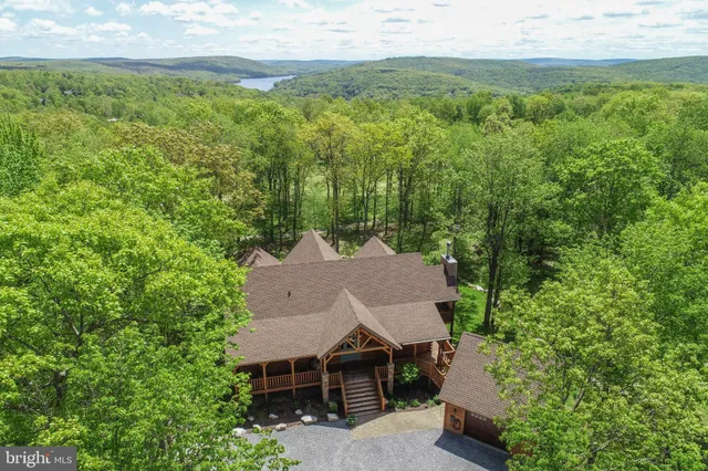 an aerial view of a house with yard and outdoor seating
