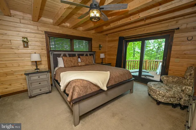 a spacious bedroom with a large bed and a large window