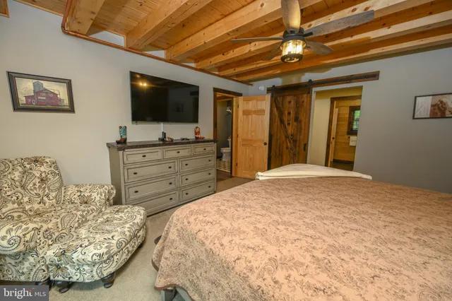 a bathroom with a double vanity sink toilet mirror and shower