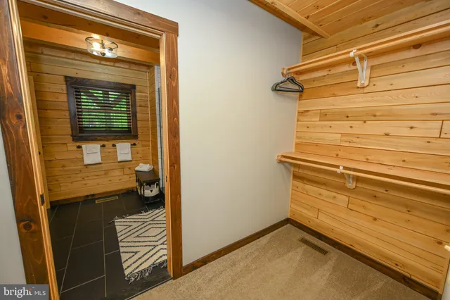 a large bed sitting in a bedroom next to a window
