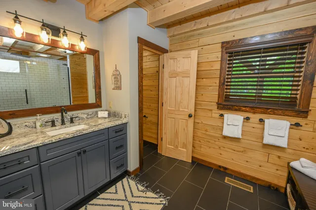 a bedroom with a bed and a flat tv screen on dresser
