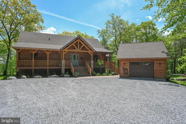 a front view of a house with a garden and garage
