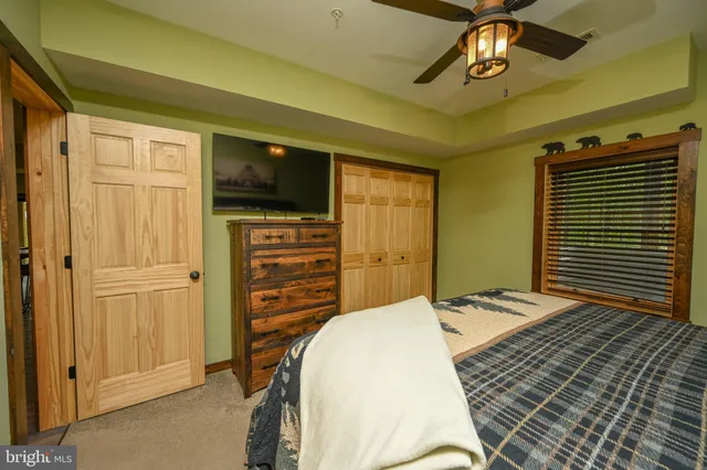 an aerial view of residential house with outdoor space and trees all around