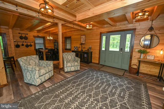 a kitchen with a table chairs and wooden floor