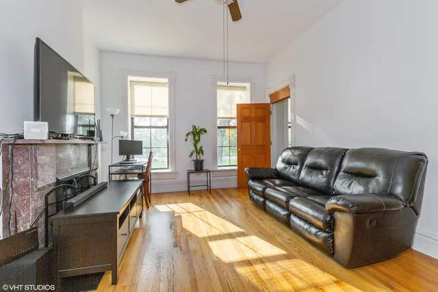 a living room with furniture stove and a table